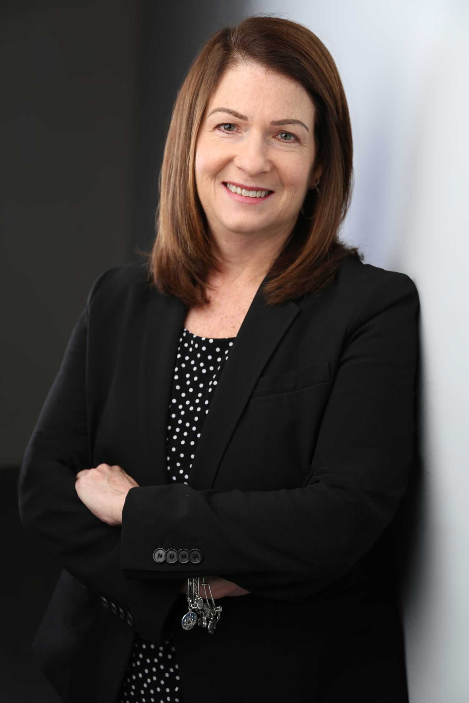 Judy McHugh standing in black suit
